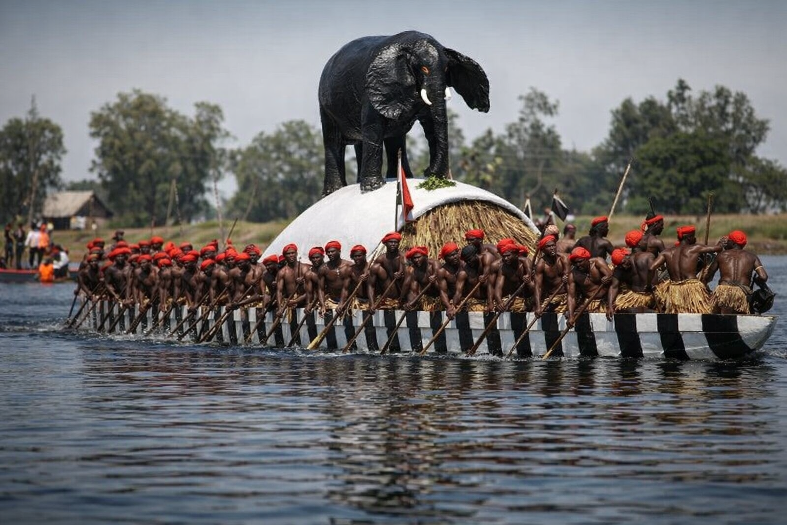 The Nalikwanda royal barge with paddlers in scarlet berets